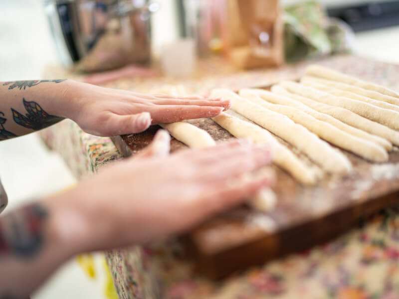 woman rolling gnocchi dough